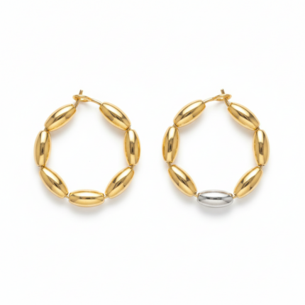 Two-tone gold and silver oval bead hoop earrings on white background