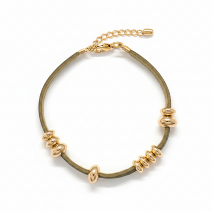 Olive suede and gold charm bracelet with rondelle spacers on white background