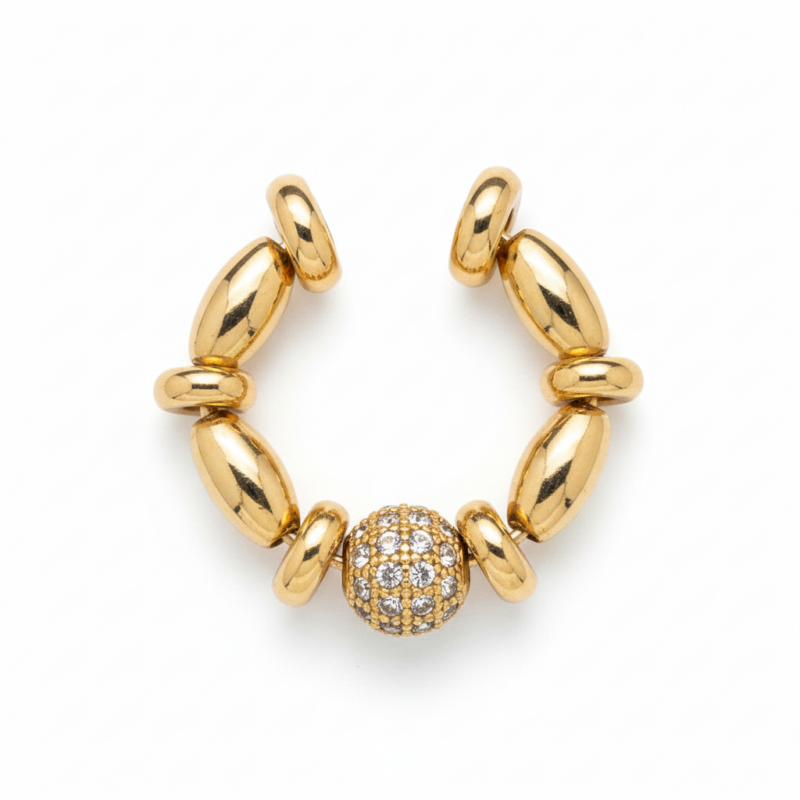 Gold oval bead and pavé crystal ear cuff on white background