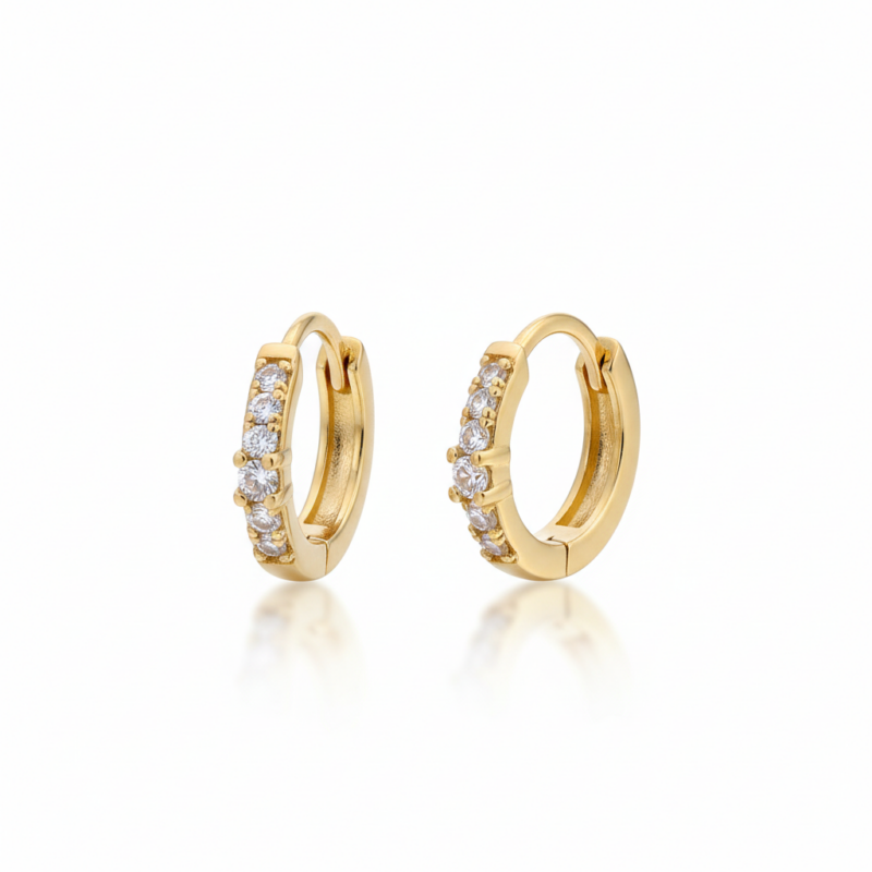 Gold hoop earrings on white background