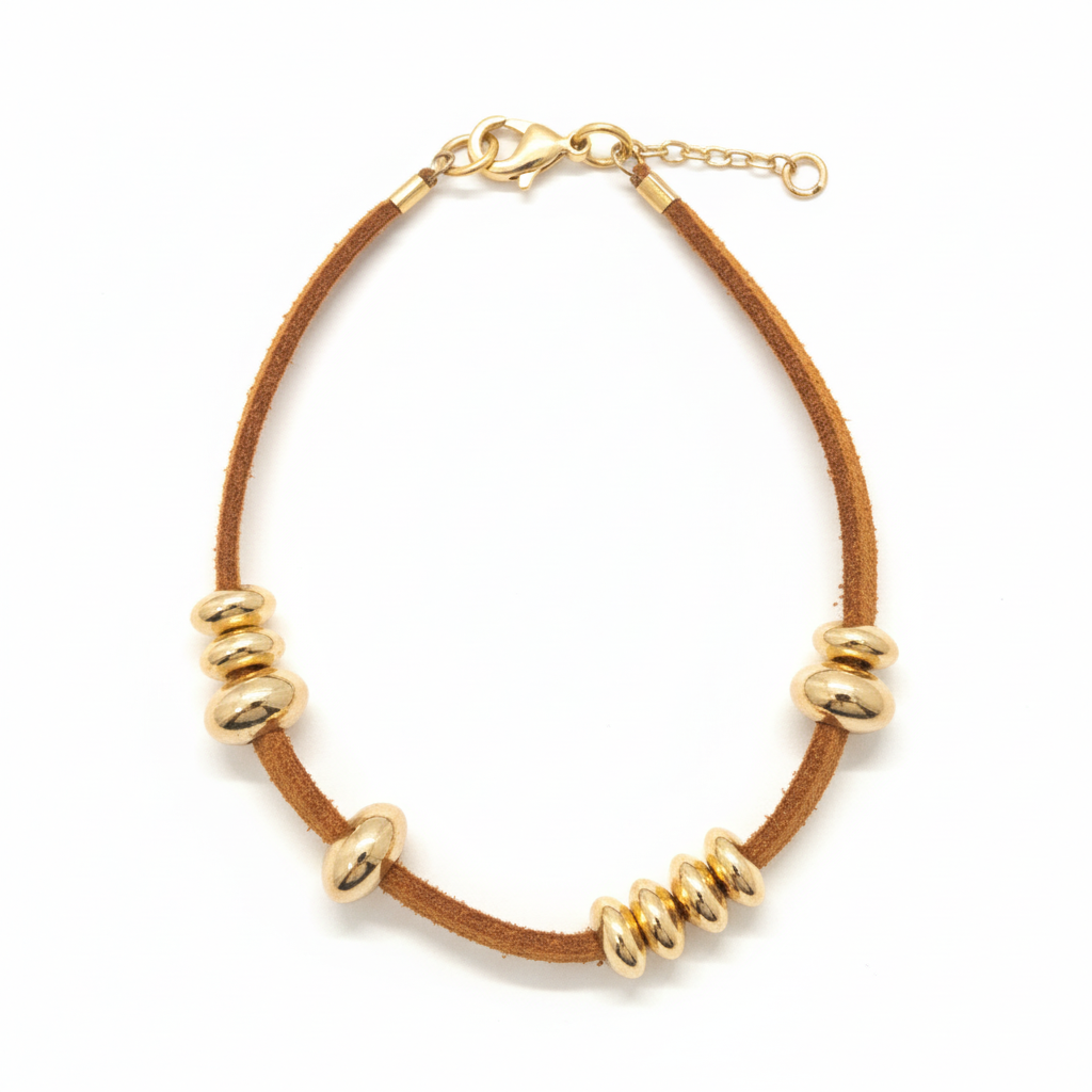 image_e7f2ba0e-c58e-4be4-8d8b-0127981192a0 Tan suede and gold oval bead bracelet with rondelle spacers on white background